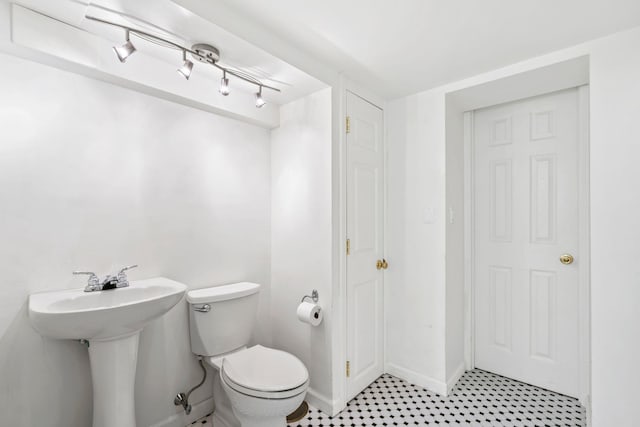74 Buckingham Rd, West Hempstead, NY 11552 - bathroom with toilet, baseboards, and a sink