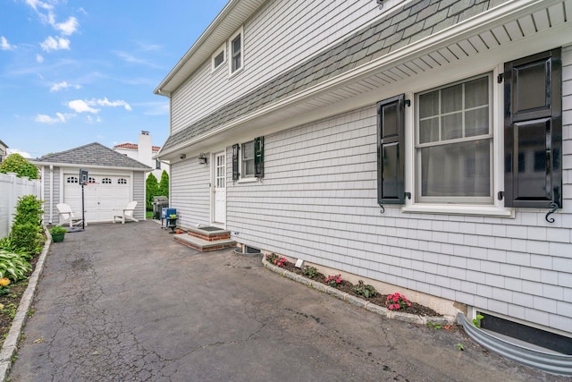 74 Buckingham Rd, West Hempstead, NY 11552 - view of property exterior with an outdoor structure and a garage