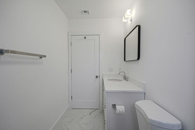 2939 N Wading River Rd, Wading River, NY 11792 - bathroom with marble finish flooring, vanity, toilet, and baseboards