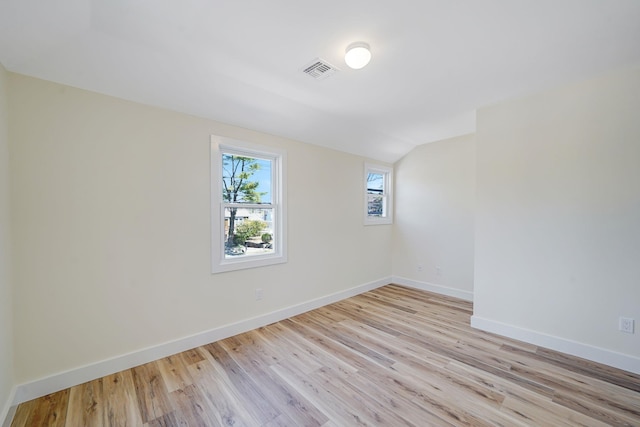 2939 N Wading River Rd, Wading River, NY 11792 - unfurnished room featuring light wood finished floors, baseboards, and vaulted ceiling