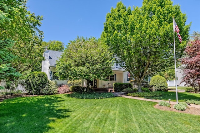 4 Pak Ct, East Setauket, NY 11733 - view of front of home with a front lawn, a chimney, and a shingled roof