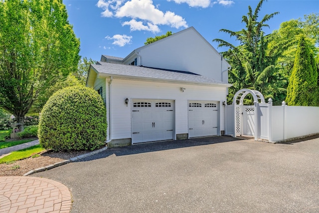 4 Pak Ct, East Setauket, NY 11733 - garage featuring asphalt driveway