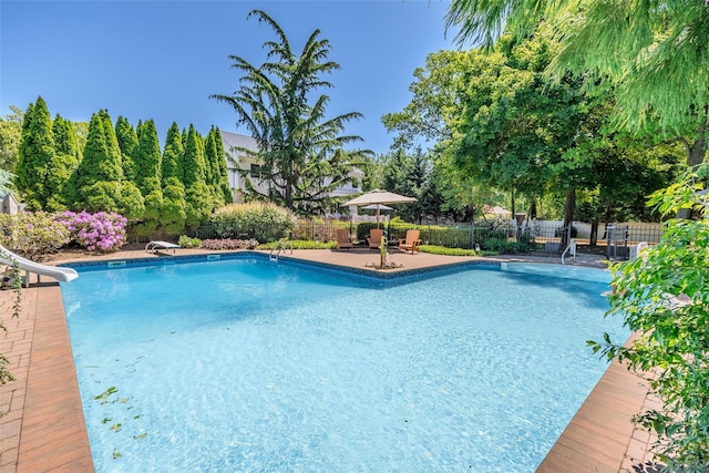 4 Pak Ct, East Setauket, NY 11733 - view of swimming pool with a fenced backyard and a water slide
