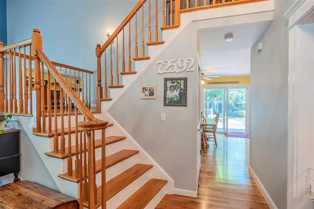 4 Pak Ct, East Setauket, NY 11733 - staircase featuring wood finished floors, ceiling fan, and baseboards