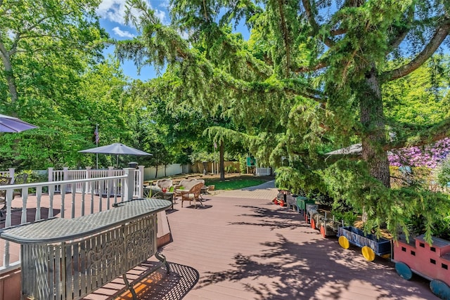 4 Pak Ct, East Setauket, NY 11733 - surrounding community featuring outdoor dining space, a deck, and view of scattered trees