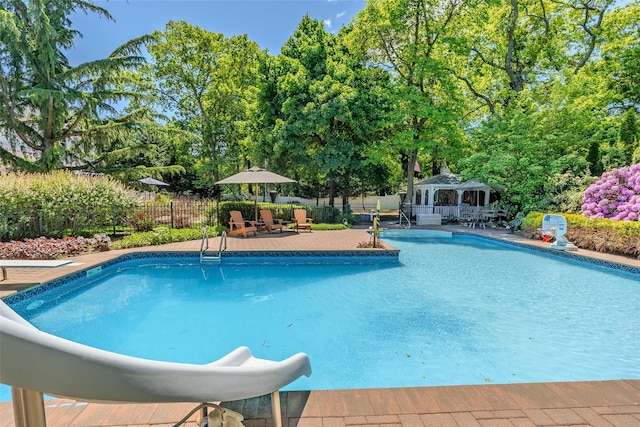 4 Pak Ct, East Setauket, NY 11733 - view of pool with a gazebo, a water slide, a patio area, and view of wooded area