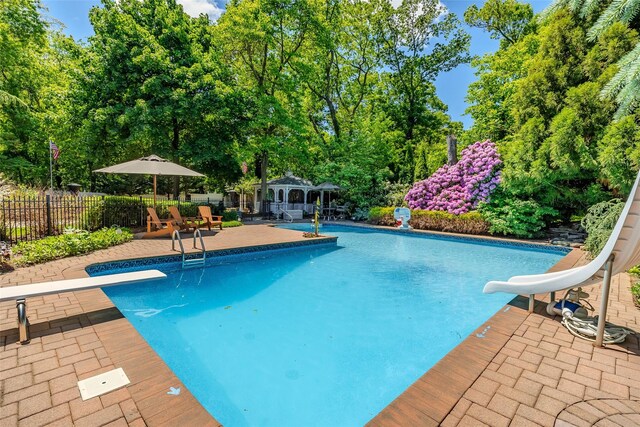 4 Pak Ct, East Setauket, NY 11733 - view of pool featuring a water slide, a storage structure, an outdoor structure, a patio, and a diving board