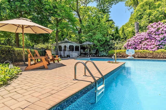 4 Pak Ct, East Setauket, NY 11733 - view of swimming pool with a gazebo, a patio, and view of wooded area