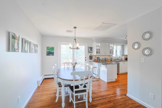 8 Country Ln, Warwick, NY 10990 - dining space with healthy amount of natural light, light wood-style flooring, a chandelier, and baseboards