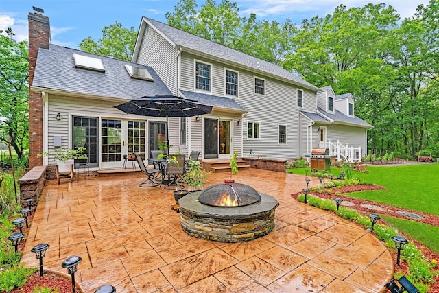 24 Hampton Ct, Wallkill, NY 12589 - rear view of house with a fire pit, a patio, a chimney, french doors, and a shingled roof