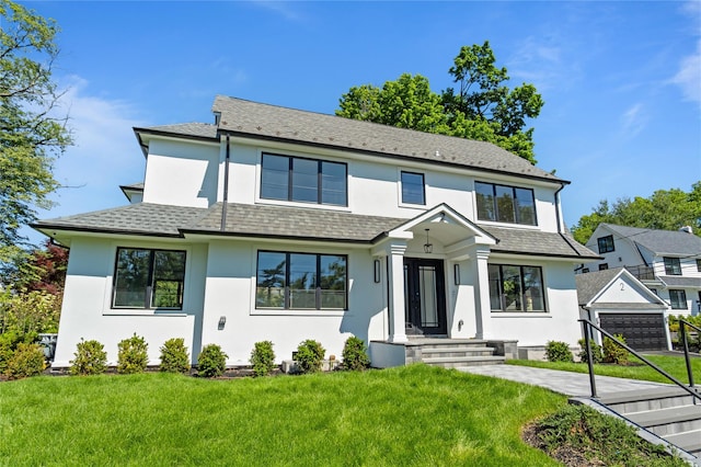 2 Henry St, Great Neck, NY 11023 - view of front of property with stucco siding and a front lawn