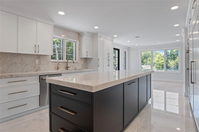 2 Henry St, Great Neck, NY 11023 - kitchen featuring stainless steel dishwasher, a sink, white cabinets, a center island, and dark cabinetry
