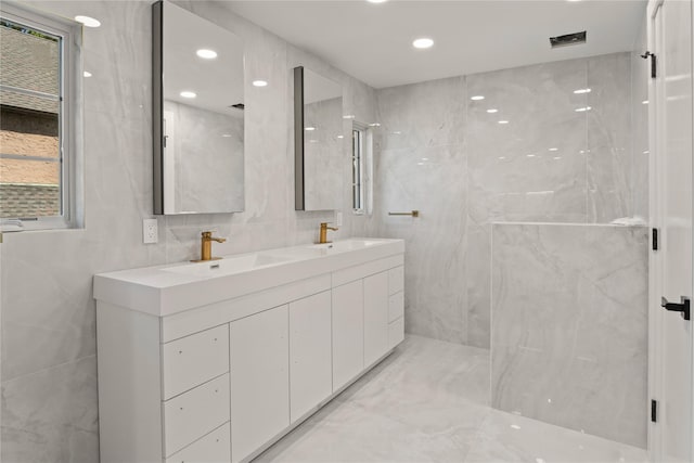 2 Henry St, Great Neck, NY 11023 - full bath with double vanity, tile walls, marble finish floors, recessed lighting, and a marble finish shower