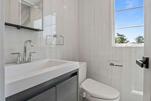2 Henry St, Great Neck, NY 11023 - bathroom featuring toilet, tile walls, and vanity
