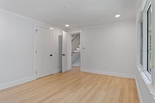 2 Henry St, Great Neck, NY 11023 - spare room with light wood-type flooring, stairs, baseboards, recessed lighting, and crown molding