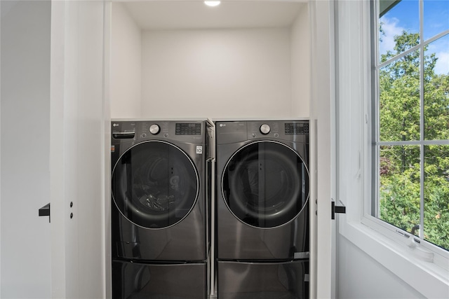 2 Henry St, Great Neck, NY 11023 - laundry area with washing machine and dryer and healthy amount of natural light