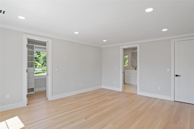 2 Henry St, Great Neck, NY 11023 - empty room featuring healthy amount of natural light, recessed lighting, light wood finished floors, baseboards, and crown molding