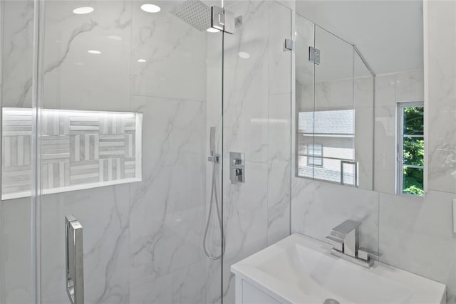 2 Henry St, Great Neck, NY 11023 - bathroom with a marble finish shower, vanity, and tile walls