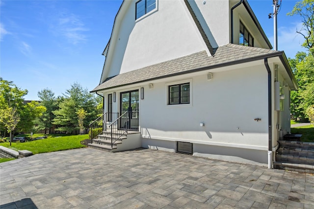 2 Henry St, Great Neck, NY 11023 - rear view of property featuring a patio area, stucco siding, and a yard