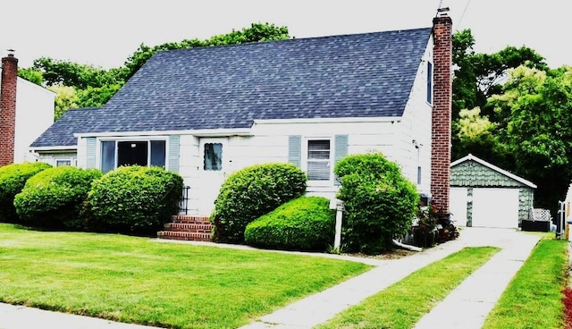465 18th St, West Babylon, NY 11704 - cape cod home featuring roof with shingles, an outdoor structure, a front lawn, a chimney, and a garage