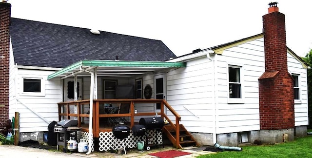 465 18th St, West Babylon, NY 11704 - rear view of property featuring a shingled roof, a chimney, and a wooden deck