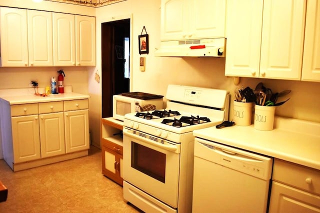 465 18th St, West Babylon, NY 11704 - kitchen with white appliances, under cabinet range hood, light countertops, and white cabinets
