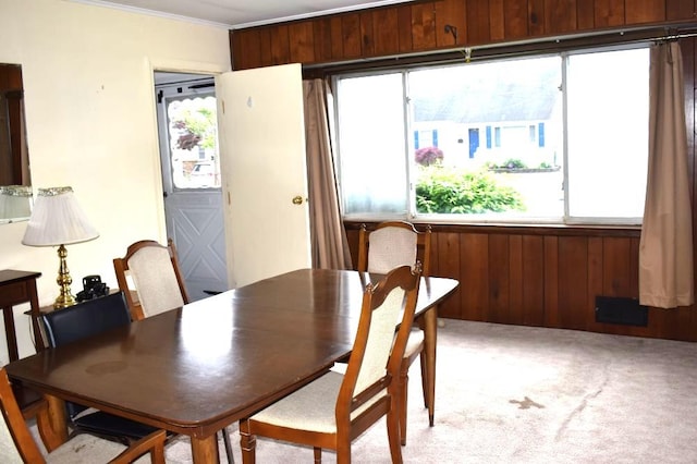 465 18th St, West Babylon, NY 11704 - dining area featuring plenty of natural light, light carpet, and ornamental molding