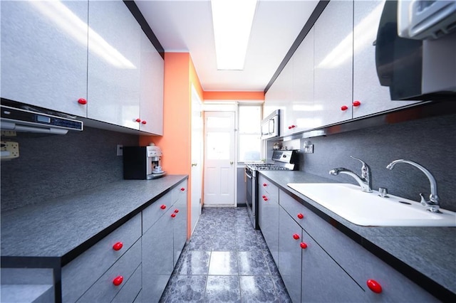 2179 E 26th St, Brooklyn, NY 11229 - kitchen featuring appliances with stainless steel finishes, a sink, and dark countertops