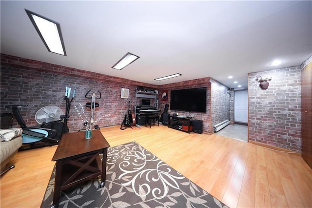 2179 E 26th St, Brooklyn, NY 11229 - living room with brick wall, wood finished floors, and a baseboard heating unit
