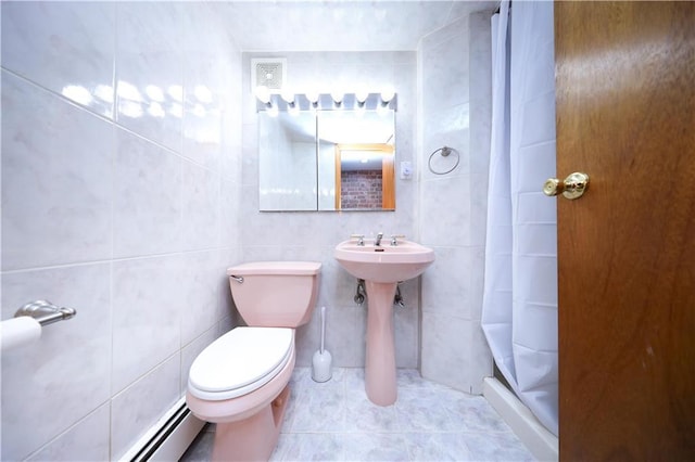 2179 E 26th St, Brooklyn, NY 11229 - bathroom featuring tile walls, a stall shower, toilet, tile patterned floors, and a baseboard heating unit