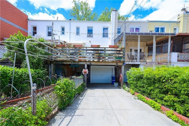 2179 E 26th St, Brooklyn, NY 11229 - rear view of house with an attached garage, driveway, and a chimney