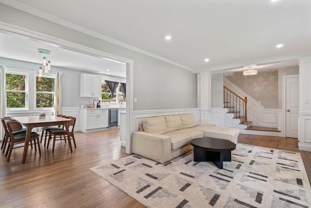 170 Lenox St, Port Jefferson Station, NY 11776 - living area with beverage cooler, light wood-type flooring, recessed lighting, wainscoting, and ornamental molding