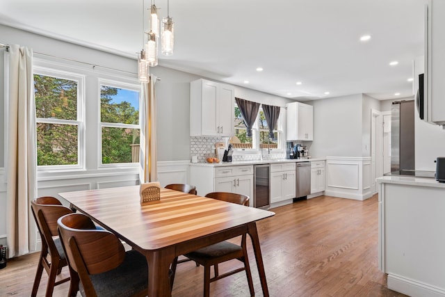 170 Lenox St, Port Jefferson Station, NY 11776 - dining room featuring beverage cooler, light wood finished floors, a decorative wall, recessed lighting, and a wainscoted wall