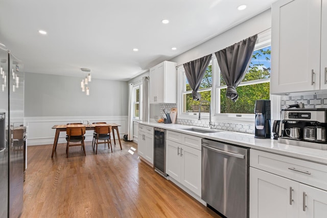 170 Lenox St, Port Jefferson Station, NY 11776 - kitchen with stainless steel appliances, a sink, beverage cooler, decorative backsplash, and a wainscoted wall