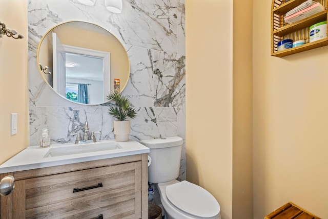 170 Lenox St, Port Jefferson Station, NY 11776 - bathroom featuring vanity, toilet, tile walls, and backsplash