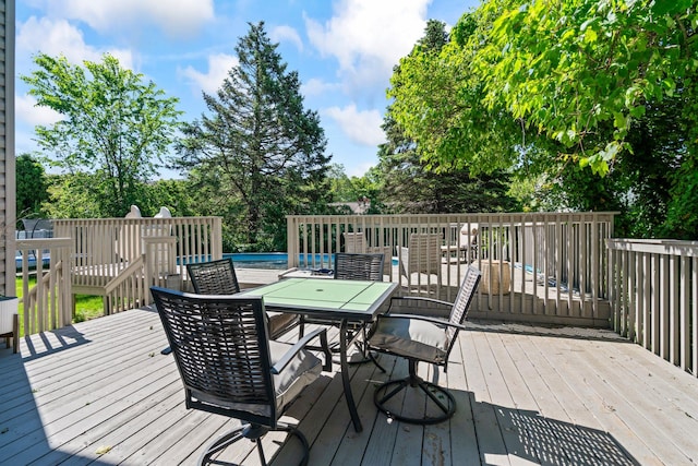 170 Lenox St, Port Jefferson Station, NY 11776 - wooden deck featuring outdoor dining space, an outdoor pool, and view of scattered trees