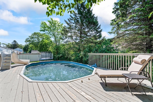 170 Lenox St, Port Jefferson Station, NY 11776 - view of pool with a trampoline, a wooden deck, and a water slide
