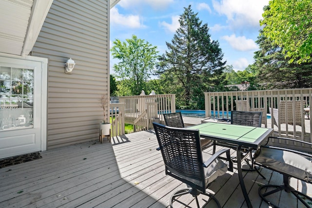 170 Lenox St, Port Jefferson Station, NY 11776 - wooden deck with outdoor dining space, an outdoor pool, and view of wooded area