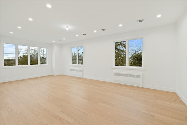 29 Calvert Dr Unit 211, Monsey, NY 10952 - unfurnished room featuring radiator, healthy amount of natural light, recessed lighting, and light wood-style floors