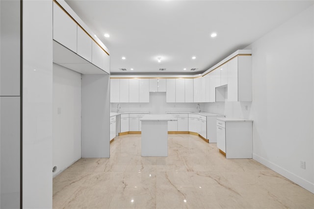29 Calvert Dr Unit 211, Monsey, NY 10952 - kitchen featuring a kitchen island, white cabinets, a sink, and recessed lighting