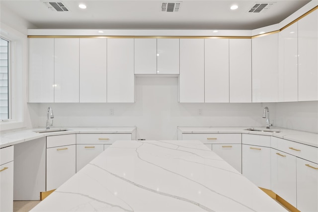29 Calvert Dr Unit 211, Monsey, NY 10952 - kitchen with a sink, modern cabinets, white cabinets, light stone countertops, and recessed lighting