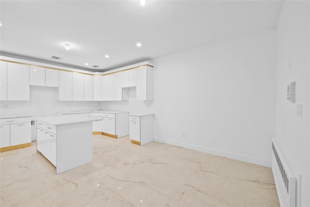 29 Calvert Dr Unit 211, Monsey, NY 10952 - kitchen with light marble finish floors, white cabinetry, modern cabinets, a center island, and recessed lighting