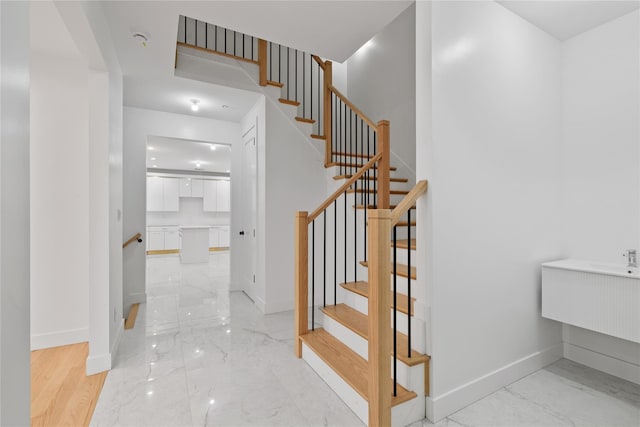 29 Calvert Dr Unit 211, Monsey, NY 10952 - staircase featuring marble tiled floors and baseboards