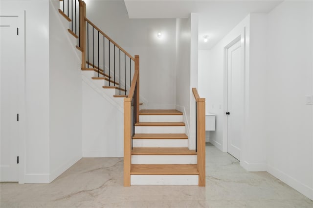 29 Calvert Dr Unit 211, Monsey, NY 10952 - staircase featuring marble look tiles and baseboards