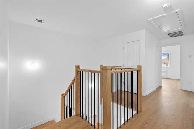 29 Calvert Dr Unit 211, Monsey, NY 10952 - hallway featuring an upstairs landing, light wood-type flooring, baseboards, and attic access