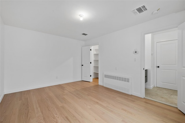 29 Calvert Dr Unit 211, Monsey, NY 10952 - empty room featuring light wood-type flooring, baseboards, and radiator heating unit