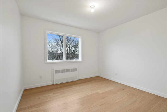 29 Calvert Dr Unit 211, Monsey, NY 10952 - spare room with radiator heating unit, light wood-type flooring, and baseboards