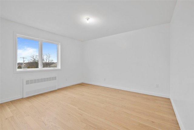 29 Calvert Dr Unit 211, Monsey, NY 10952 - empty room featuring radiator heating unit, light wood finished floors, and baseboards