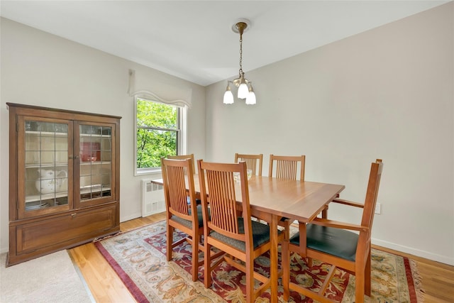177 E Hartsdale Ave Unit 5L, Hartsdale, NY 10530 - dining area with radiator, light wood finished floors, a chandelier, and baseboards