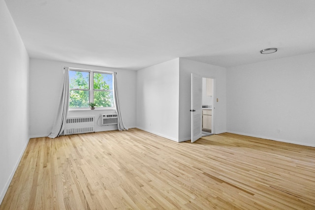 642 Locust St Unit 3K, Mount Vernon, NY 10552 - empty room featuring radiator heating unit, wood finished floors, a wall mounted air conditioner, and baseboards